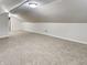 Attic room with light walls, carpet flooring, and a slanted ceiling at 205 S Market St, Thorntown, IN 46071