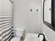 Cozy bathroom featuring a white sink, toilet, and decorative gray and white striped shower curtain at 205 S Market St, Thorntown, IN 46071