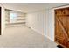 Bedroom with a wood door, light walls, carpet flooring, a small window and white shelving at 205 S Market St, Thorntown, IN 46071