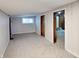Bedroom with wood doors, light walls, carpet flooring, and a small window at 205 S Market St, Thorntown, IN 46071