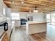 Kitchen featuring a kitchen island, wood ceiling, and stainless steel appliances at 205 S Market St, Thorntown, IN 46071