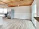 Spacious kitchen boasting stainless steel appliances, wood floors, and sliding glass door at 205 S Market St, Thorntown, IN 46071