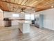Open-concept kitchen with stainless steel appliances, white cabinets, and wooden countertops at 205 S Market St, Thorntown, IN 46071