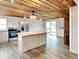 Kitchen featuring a kitchen island, wood ceiling, and stainless steel appliances at 205 S Market St, Thorntown, IN 46071