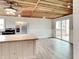 Bright kitchen featuring stainless steel appliances, light wood floors, and island with deck access at 205 S Market St, Thorntown, IN 46071