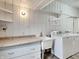 Bright laundry room with white cabinets, sink, countertop, and washer/dryer at 205 S Market St, Thorntown, IN 46071