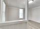 Light-filled living room with laminate floors, large windows, and white trim at 205 S Market St, Thorntown, IN 46071