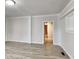 Bright living room featuring light-colored laminate flooring, white trim, and an open doorway at 205 S Market St, Thorntown, IN 46071