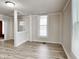 Bright living room featuring light-colored laminate flooring, white trim, and an open doorway at 205 S Market St, Thorntown, IN 46071