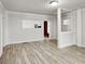 Open-concept living room with laminate floors, white trim, and a view into another room at 205 S Market St, Thorntown, IN 46071