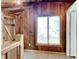 Cozy room with wooden walls, wood ceiling, plush carpet, and window with blinds at 205 S Market St, Thorntown, IN 46071
