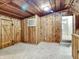 Room features carpet, wood paneling, wood ceiling, window, and doorway at 205 S Market St, Thorntown, IN 46071