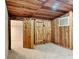 Room with wooden walls and ceiling, carpet flooring, wooden door, and doorway at 205 S Market St, Thorntown, IN 46071