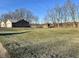 Backyard featuring lawn, home, trees, and fencing at 2129 Heather Rd, Anderson, IN 46012