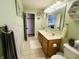 Bathroom with a double sink vanity, tile flooring, and green painted walls at 2129 Heather Rd, Anderson, IN 46012
