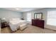 Bright bedroom with large windows, dresser and white bedding at 2129 Heather Rd, Anderson, IN 46012