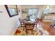 Well-lit dining area with a round table, decorative rug, and a view of the deck at 2129 Heather Rd, Anderson, IN 46012