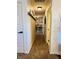 Hallway with carpeted floors, neutral walls, white doors, and decorative shelves at 2129 Heather Rd, Anderson, IN 46012
