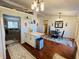Open kitchen and dining area with wood floors, stainless steel appliances and generous natural lighting at 2129 Heather Rd, Anderson, IN 46012
