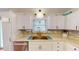 Well-lit kitchen featuring stainless steel appliances, white cabinets, and a stylish backsplash at 2129 Heather Rd, Anderson, IN 46012