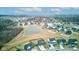 Breathtaking aerial view of a residential community featuring a tranquil pond and beautifully landscaped yards at 2627 Chalbury Dr, Plainfield, IN 46168