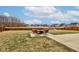 Expansive backyard featuring a fire pit area, lush lawn, playground, and views of the nearby pond at 2627 Chalbury Dr, Plainfield, IN 46168