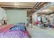 Unfinished basement with exposed ceiling, a bed, and lots of space for storage at 2627 Chalbury Dr, Plainfield, IN 46168