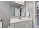 Bright bathroom featuring a white vanity with a modern sink and a large mirror at 2627 Chalbury Dr, Plainfield, IN 46168