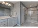 Well-lit bathroom features a double sink vanity with a quartz countertop and walk-in shower at 2627 Chalbury Dr, Plainfield, IN 46168
