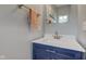 Stylish half bathroom with a navy blue vanity, white countertop, modern faucet, and a framed mirror at 2627 Chalbury Dr, Plainfield, IN 46168