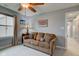 Bedroom features a sofa with pillows, a ceiling fan, and a bright window at 2627 Chalbury Dr, Plainfield, IN 46168
