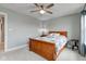 Neutral bedroom features a wooden bed, ceiling fan, and a bright window at 2627 Chalbury Dr, Plainfield, IN 46168