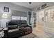 Comfortable bedroom showcasing a plush couch, gray walls, and a cozy window with blinds at 2627 Chalbury Dr, Plainfield, IN 46168