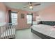 Cozy bedroom with a crib, bed and two windows providing natural light at 2627 Chalbury Dr, Plainfield, IN 46168
