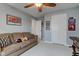 Bedroom features a sofa, wall art, ceiling fan, and multiple doors at 2627 Chalbury Dr, Plainfield, IN 46168