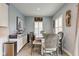 Charming dining room showcases decor, rustic wood table, and windows dressed in plantation shutters at 2627 Chalbury Dr, Plainfield, IN 46168