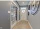 Inviting foyer features wood flooring, glass panel french doors, and decorative wall clock at 2627 Chalbury Dr, Plainfield, IN 46168