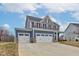 Charming home with a three-car garage, blue and gray siding with a well-maintained lawn at 2627 Chalbury Dr, Plainfield, IN 46168