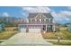 Attractive two-story home with a well-kept lawn, three-car garage, and a welcoming front entrance with decor at 2627 Chalbury Dr, Plainfield, IN 46168