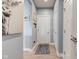 Bright hallway with decor, light wood-look flooring, and multiple white doors at 2627 Chalbury Dr, Plainfield, IN 46168