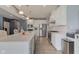 Open kitchen featuring stainless steel appliances, white cabinets and countertops, and an island with seating at 2627 Chalbury Dr, Plainfield, IN 46168