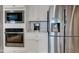 Gourmet kitchen features stainless steel appliances and sleek white cabinetry at 2627 Chalbury Dr, Plainfield, IN 46168
