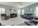 Spacious living room with modern furniture, plush carpeting, and a large flat-screen TV at 2627 Chalbury Dr, Plainfield, IN 46168