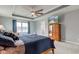 Spacious primary bedroom with a large bed, a wood dresser with mirror, and a ceiling fan at 2627 Chalbury Dr, Plainfield, IN 46168