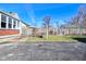 A nice backyard with a patch of green grass and an asphalt driveway at 3533 N Grant Ave, Indianapolis, IN 46218