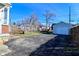 Spacious backyard with a detached garage and mature trees, offering ample space for outdoor activities and parking at 3533 N Grant Ave, Indianapolis, IN 46218