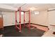 Basement featuring rubber floor tiles and a red weightlifting rack at 3533 N Grant Ave, Indianapolis, IN 46218