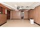 Partially finished basement with wood paneling and an open doorway leading to stairs, offering versatile living space at 3533 N Grant Ave, Indianapolis, IN 46218
