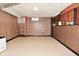 Spacious basement with wood-paneled walls and vinyl flooring, ready for various uses and ample storage at 3533 N Grant Ave, Indianapolis, IN 46218