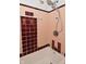 Classic bathroom with a vintage-style shower head, peach tiles, and clean white surfaces at 3533 N Grant Ave, Indianapolis, IN 46218